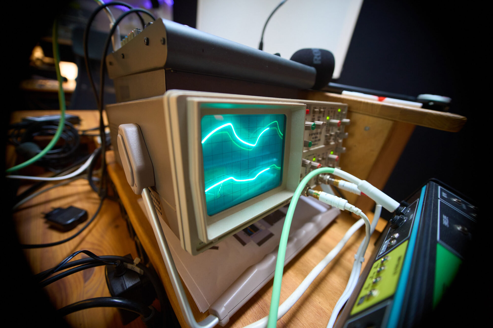 An old analog oscilloscope displaying waveforms.